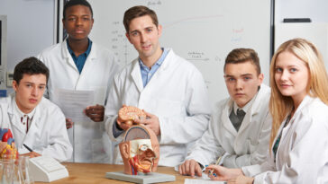 Teacher with students in biology class